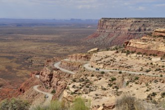 Serpentine road snakes through a rocky desert landscape with sweeping views, Monument Valley,