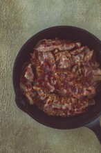 Crispy bacon, in a cast-iron skillet, rustic style, no people