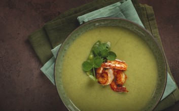Pea cream soup, with shrimp, green soup, homemade, top view, no people