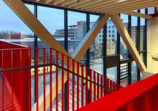 Staircase with signal red color scheme in seminar building H of Bochum University in the evening