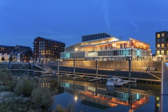 Primark on Maasboulevard and city harbor in Venlo at dusk, the Netherlands