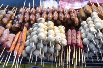 A selection of grilled pork meat sausages including Sai Krok Isan and Moo Ping, satay style meat on