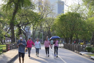 Bangkok, Thailand. March 4th 2025. People enjoy walking and jogging in the urban green space of
