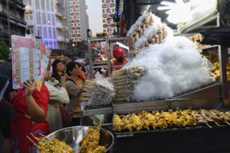 Bangkok, Thailand. February 18th 2025. Popular street food stalls along a crowded Yaowarat Road,