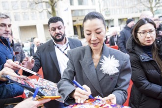 Michelle Yeoh signs autographs ahead of the premiere of the film Everything Everywhere All At Once