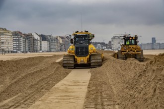 Bulldozers when distributing sand on the beach in the town of Knokke-Heist, part of coastal