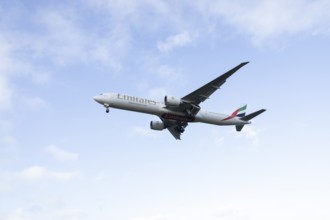 Boeing 777 commercial passenger airliner jet aircraft of Emirates airways in flight on approach to
