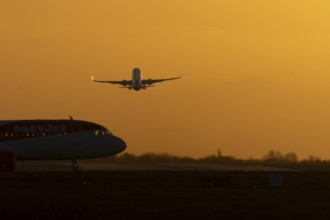 Airbus commercial passenger airliner jet aircraft taking off in flight with another plane on the