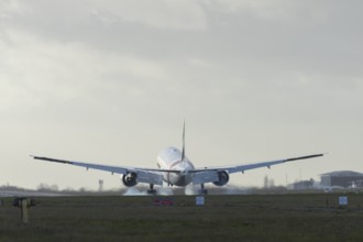 Boeing 777 commercial passenger airliner jet aircraft of Emirates airways landing on the runway at