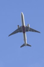Boeing 777 commercial passenger airliner jet aircraft of Emirates airways in flight at London