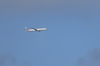 Boeing 777 commercial passenger airliner jet aircraft of Emirates airways in flight at London