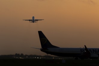 Airbus commercial passenger airliner jet aircraft taking off in flight at sunset at London Stansted
