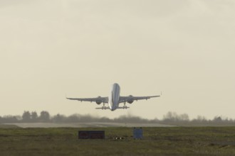 Airbus commercial passenger airliner jet aircraft taking off in flight at London Stansted airport,