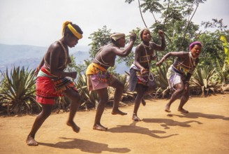 Zulu woman dancers dressed in traditional attire, performing at an outdoor cultural event likely
