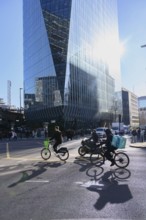 London, UK. January 31st 2025. A Lime bike and delivery rider cycle through a busy traffic