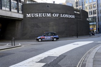 London, UK. January 31st 2025. A classic London black cab passing the Museum of London, covering