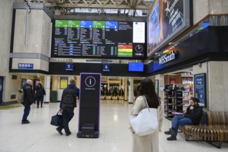 London, UK. January 30th 2025. Passengers waiting in front of the train departure time display