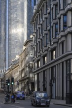 London, UK. January 29th 2025. Traditional London cabs drive along historic Threadneedle Street in