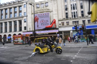 London, UK. January 30th 2025. A yellow tricycle passes the The Dominion Theatre showing The Devil