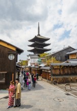 Couple in kimono, Yasaka dori historic street in the old town with traditional Japanese houses,