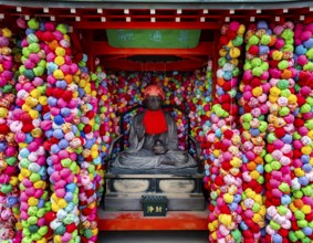 Colorful kukurizaru balls and Buddha statue, Yasaka Koshin-do Temple, Higashiyama, Kyoto, Japan