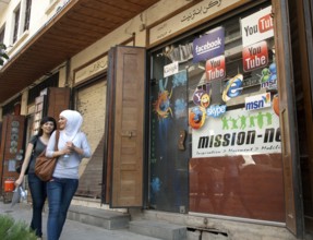Damascus, Syria. 18th September 2011 Two Syrian girls walking past an internet cafe on the Street