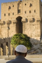 Aleppo, Syria. September 5th 2010 An old Syrian man sits in front of the entrance to the Citadel of