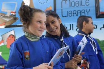 Latakia Countryside, Syria. October 18th 2010 Syrian schoolchildren collecting books from a mobile