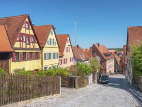 Street with typical town houses, wooden fences and cobblestones, Dinkelsbühl, Ansbach district,