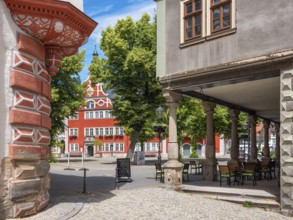 Houses and arcades on the market square in the historic old town, in the back the town hall,