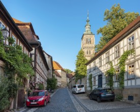 Street with half-timbered houses and cobblestones at the Gothic St. Mary's Church, Königsberg in