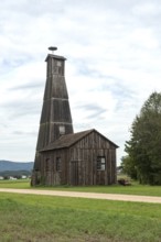 A tall wooden farm building or barn with a storks nest, typical architecture in the Swiss