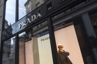 Vienna, Austria. October 15th 2024 Prada store front sign and mannequin display, a popular luxury
