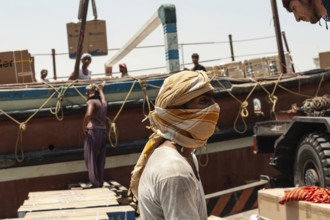 Dubai, United Arab Emirates. June 29th 2019 Foreign workers unloading cargo from Dhow boats Dubai