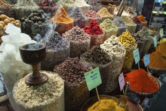 Dubai, United Arab Emirates. July 1st 2019 Incense burning alongside coloured spices for sale in