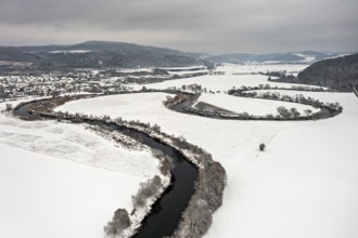 A quiet river landscape with curved river lines in snowy surroundings, hills in the background, The