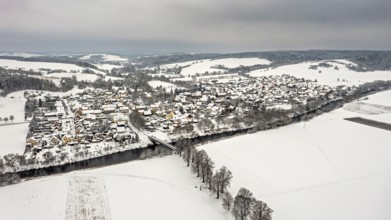 Snowy village with river and hills in the background, quiet winter atmosphere, Lauchröden in