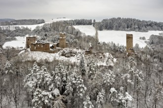 Old castle ruins in a snowy, wooded winter landscape, The Brandenburg in the Werra Valley near