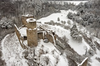 Snowy castle ruins in a wintry landscape with forest and hills, The Brandenburg in the Werra Valley