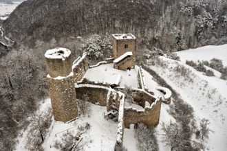 Old castle ruins with snow-covered towers and walls on a hill, The Brandenburg in the Werra Valley