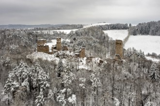 Snowy castle ruins in a wooded winter landscape, surrounded by rolling hills, The Brandenburg in