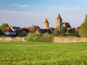 View over a meadow in the Altmühltal valley to the historic old town of Ornbau in the evening