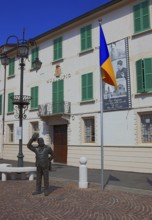 Italy, village of Brescello, the town hall, known from Don Camillo and Peppone, with a bronze