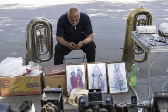 Tbilisi, Georgia. July 11th 2025. Street stall vendor at the Dry Bridge Flea Market selling
