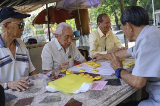 Bangkok, Thailand. March 4th 2025. Old men play Chinese board games on a Sunday morning in Lumphini
