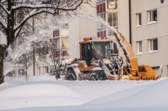Snow blower clears snow on street in Ystad, Skåne County, Sweden, Scandinavia