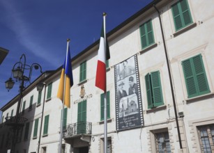 Italy, village of Brescello, the town hall, known from Don Camillo and Peppone, with a bronze