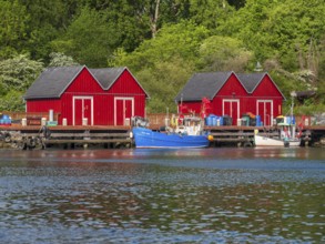 Small red huts and fishing boats in Boltenhagen fishing port, Baltic resort Boltenhagen,
