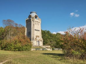 The Bismarck Tower at Großer Fallstein in autumn under a blue sky with fair weather clouds,