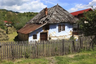 Traditional Romanian farmhouse that is in a dilapidated or abandoned state. The eye-catching light